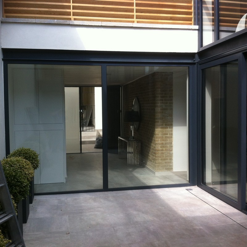 Floor-to-ceiling sliding doors opening to courtyard in Olympic Park