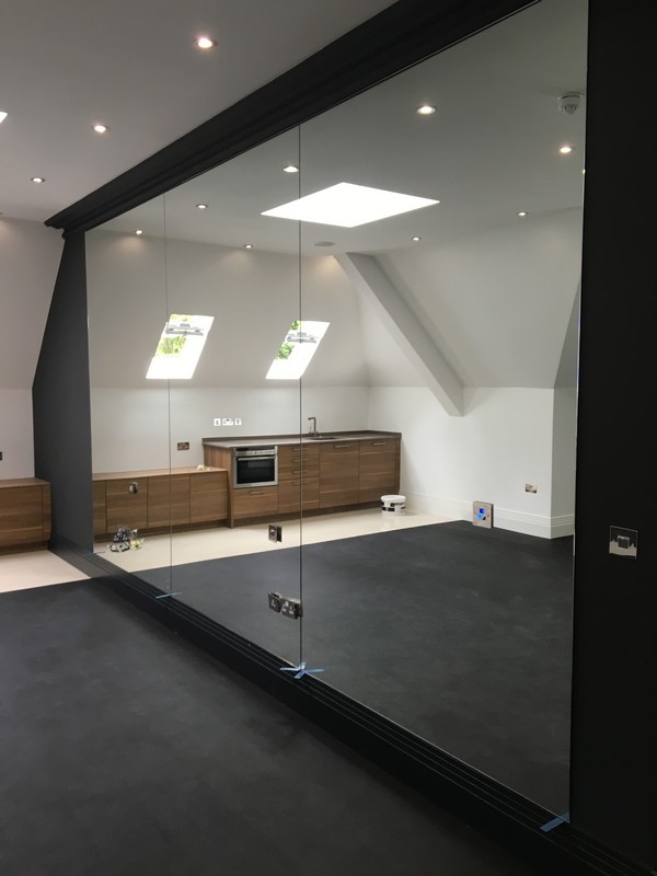 Frameless glass partition in loft conversion by Olympic Park glaziers