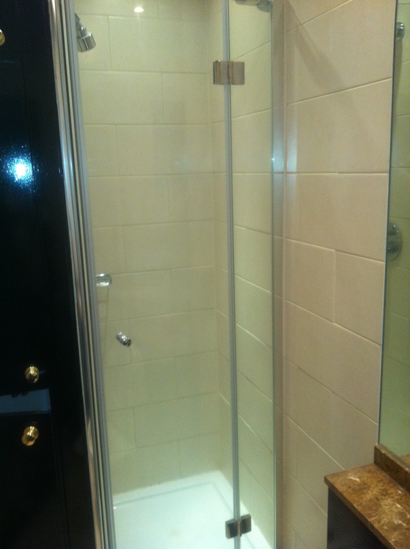Frameless glass shower enclosure with chrome fittings in Olympic Park