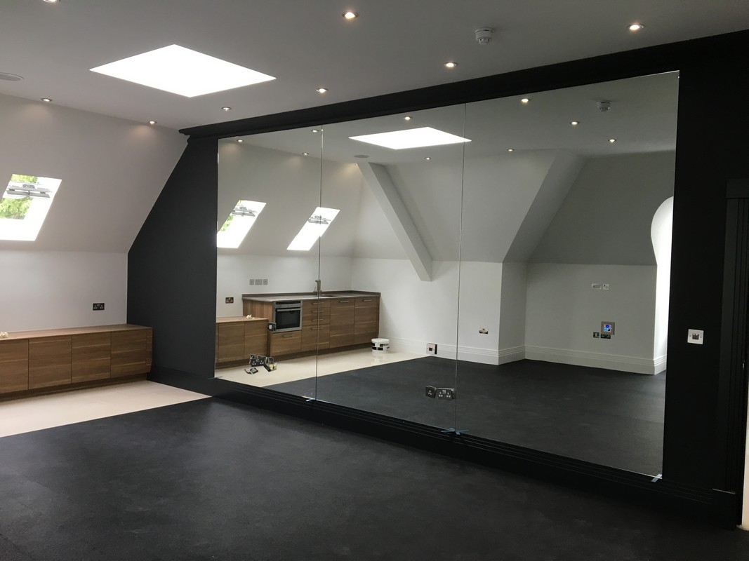 Frameless glass wall dividing loft conversion in Olympic Park